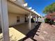 Covered patio with a ceiling fan, overlooks a landscaped backyard with shrubs and decorative rock at 8872 Perfect Diamond Ct, Las Vegas, NV 89129