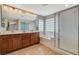 Elegant bathroom with double vanity, tub, and glass-enclosed shower, designed for comfort at 9416 Highview Rock Ct, Las Vegas, NV 89149