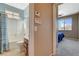 Cozy bathroom with a shower-tub combo and vanity with good lighting and a view to the bedroom at 9416 Highview Rock Ct, Las Vegas, NV 89149