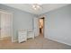 This carpeted bedroom features a desk and an ensuite bathroom at 9416 Highview Rock Ct, Las Vegas, NV 89149