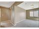 Carpeted bonus room featuring neutral color scheme and ample natural light through a window at 9416 Highview Rock Ct, Las Vegas, NV 89149