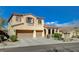 Two-story home featuring a three-car garage and desert landscaping at 9416 Highview Rock Ct, Las Vegas, NV 89149