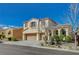 Two-story home featuring a three-car garage and desert landscaping at 9416 Highview Rock Ct, Las Vegas, NV 89149