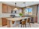 Kitchen featuring granite countertops, stainless steel appliances, island with barstool seating and recessed lighting at 9416 Highview Rock Ct, Las Vegas, NV 89149