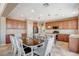 Open kitchen boasts a kitchen island, stainless steel appliances and a breakfast nook with lots of natural light at 9416 Highview Rock Ct, Las Vegas, NV 89149