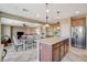 Bright open kitchen with stainless steel appliances, kitchen island and open concept to dining and living areas at 9416 Highview Rock Ct, Las Vegas, NV 89149