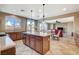 Bright kitchen with an island featuring pendant lights and wood cabinets at 9416 Highview Rock Ct, Las Vegas, NV 89149