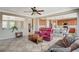 Open concept living room boasts tile flooring, ceiling fan and is conveniently open to the kitchen and dining area at 9416 Highview Rock Ct, Las Vegas, NV 89149