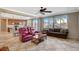 Open concept living room features tile flooring, ceiling fan and lots of natural light from the bright windows at 9416 Highview Rock Ct, Las Vegas, NV 89149