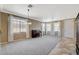 Large living room with neutral walls and carpeted flooring at 9416 Highview Rock Ct, Las Vegas, NV 89149