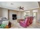 Bright living room features tile flooring, ceiling fan and open floor plan to the kitchen and dining area at 9416 Highview Rock Ct, Las Vegas, NV 89149