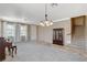 Large living room with stairway, neutral walls, and carpeted flooring at 9416 Highview Rock Ct, Las Vegas, NV 89149