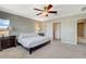 Inviting main bedroom with ceiling fan, dark wood furnishings, and a walk-in closet at 9416 Highview Rock Ct, Las Vegas, NV 89149