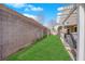 Spacious backyard with lawn and a modern hot tub under a covered patio, ideal for entertainment at 943 Sedona Rd, Henderson, NV 89014
