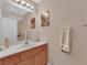 Bathroom featuring wood vanity, sink, mirror, and towel rack at 943 Sedona Rd, Henderson, NV 89014