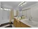 Bright bathroom featuring double sinks, a large mirror, and a shower-tub combo at 943 Sedona Rd, Henderson, NV 89014