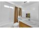 Bright bathroom featuring a shower-tub combo and a toilet and sink with a mirror at 943 Sedona Rd, Henderson, NV 89014