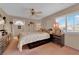 Comfortable bedroom featuring a ceiling fan and a window with plantation shutters at 943 Sedona Rd, Henderson, NV 89014