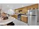 Kitchen area features wood cabinets, tile countertops, and stainless steel appliances at 943 Sedona Rd, Henderson, NV 89014