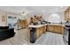 Kitchen and living area offers wood cabinets, tile flooring and countertops, and stainless steel appliances at 943 Sedona Rd, Henderson, NV 89014