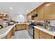 Kitchen with wooden cabinets, tile countertops, and stainless steel appliances at 943 Sedona Rd, Henderson, NV 89014