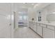 Bathroom featuring double sinks, sleek cabinets, and easy access to the bedroom at 964 Norwood Heights Ln, Las Vegas, NV 89138
