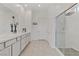 Bright bathroom with a double vanity, large mirror, and a modern walk-in shower at 964 Norwood Heights Ln, Las Vegas, NV 89138