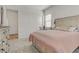 Cozy bedroom with neutral tones, plush carpet, and a decorative headboard at 964 Norwood Heights Ln, Las Vegas, NV 89138