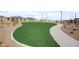 Well-maintained community dog park with artificial grass and walking path at 964 Norwood Heights Ln, Las Vegas, NV 89138