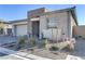 Charming single-story home featuring a stone facade, desert landscaping, and attached two-car garage at 964 Norwood Heights Ln, Las Vegas, NV 89138