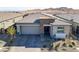 Charming single-story home featuring a stylish stone facade, a two-car garage, and a well-manicured front yard at 964 Norwood Heights Ln, Las Vegas, NV 89138