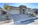 Driveway with pavers leads to garage and front door of modern home at 964 Norwood Heights Ln, Las Vegas, NV 89138