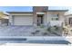 Modern home features stone accents, desert landscaping, and a paved driveway at 964 Norwood Heights Ln, Las Vegas, NV 89138