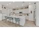 Modern kitchen features white cabinets, a center island with seating, and stainless steel appliances at 964 Norwood Heights Ln, Las Vegas, NV 89138