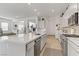Spacious kitchen with an open layout, a large island, stainless steel appliances, and wood-look floors at 964 Norwood Heights Ln, Las Vegas, NV 89138