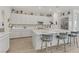 Modern kitchen features white cabinetry, a large island with seating, and stainless steel appliances at 964 Norwood Heights Ln, Las Vegas, NV 89138