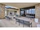 Outdoor patio featuring stone columns, large glass doors, and comfortable seating at 964 Norwood Heights Ln, Las Vegas, NV 89138