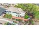 Aerial view of a home with a green turf backyard, pergola covered patio, surrounded by trees and a brick wall at 10223 Aragon Crown Rd, Las Vegas, NV 89135