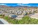 An aerial view of a residential area nestled beneath picturesque mountains and under a beautiful blue sky at 10223 Aragon Crown Rd, Las Vegas, NV 89135