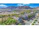 Scenic aerial view of a neighborhood showcasing well-maintained homes, lush trees, and mountain views at 10223 Aragon Crown Rd, Las Vegas, NV 89135