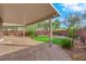 Covered back patio boasting brick pavers and well-maintained landscaping at 10223 Aragon Crown Rd, Las Vegas, NV 89135