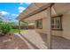 An inviting covered backyard patio featuring a well-paved stone area and direct access to the house at 10223 Aragon Crown Rd, Las Vegas, NV 89135
