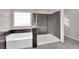 Modern bathroom featuring a luxurious soaking tub and separate glass-enclosed shower at 10223 Aragon Crown Rd, Las Vegas, NV 89135