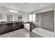 Bathroom with a soaking tub, walk-in shower, and a double sink vanity at 10223 Aragon Crown Rd, Las Vegas, NV 89135