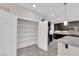 Bright kitchen featuring a pantry with shelving and stainless steel appliances at 10223 Aragon Crown Rd, Las Vegas, NV 89135