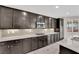 Gourmet kitchen features dark cabinets, stainless appliances and granite counters at 10223 Aragon Crown Rd, Las Vegas, NV 89135