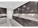 Gourmet kitchen with stainless appliances, spacious counters, and dark wood cabinets at 10223 Aragon Crown Rd, Las Vegas, NV 89135