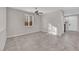 Bright living room with neutral paint, ceiling fan, large window, and modern tile flooring at 10223 Aragon Crown Rd, Las Vegas, NV 89135
