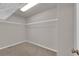 Spacious walk-in closet with built-in shelving and plush carpeting at 10223 Aragon Crown Rd, Las Vegas, NV 89135