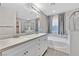 Bathroom featuring double vanity, soaking tub, and glass shower at 10574 Siesta Key St, Las Vegas, NV 89141